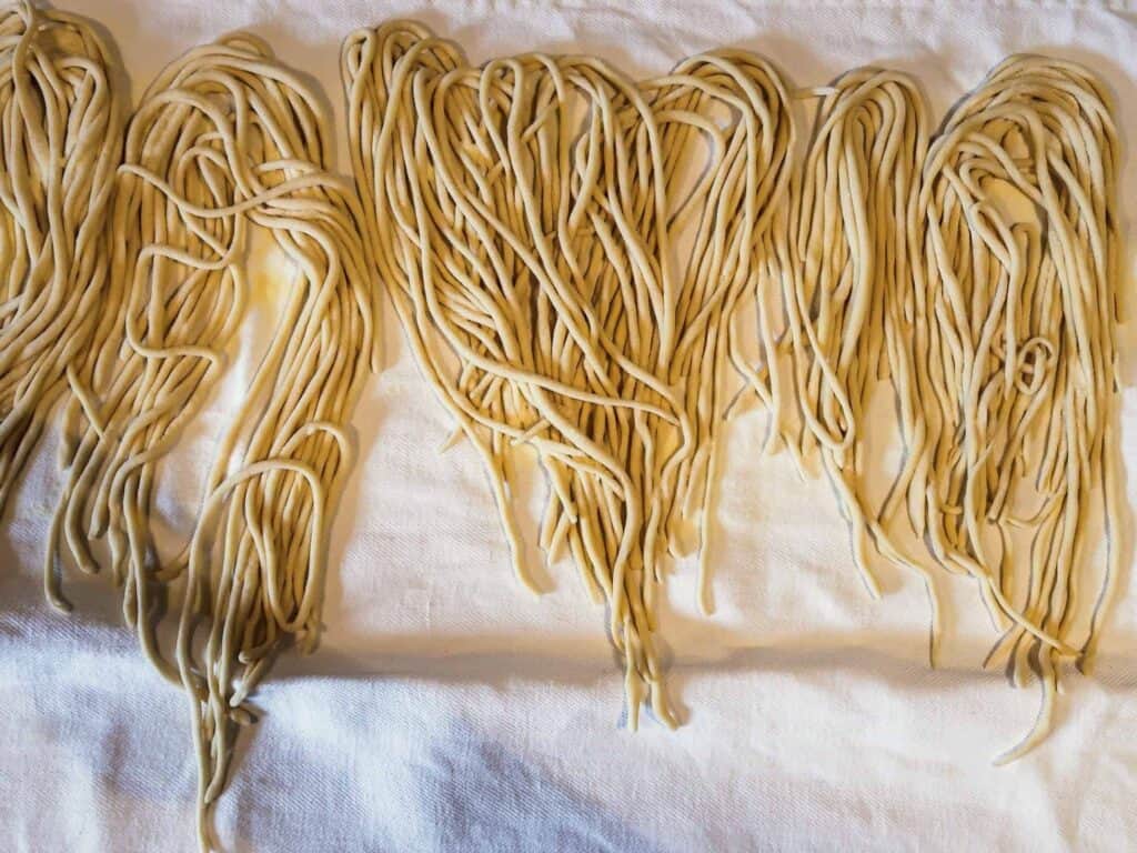 Fresh Italian pasta on a white kitchen towel.