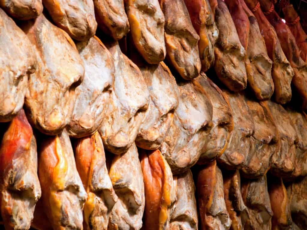 Jambon de Bosses hung while they are being cured one by one closely packed in