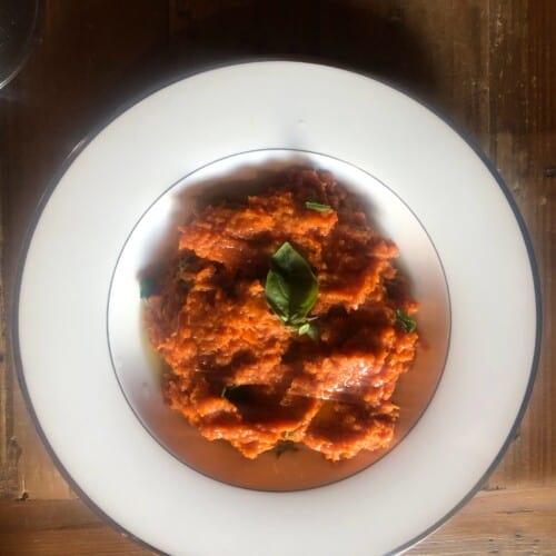 white bowl of pappa al pomodoro on a wooden table.