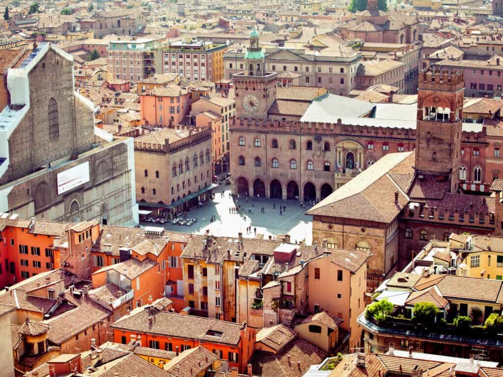 top view of main square in bologna with lots of brown and golden buildings all around 