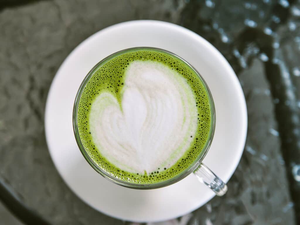 caffe matcha from top view on white saucer on dark background
