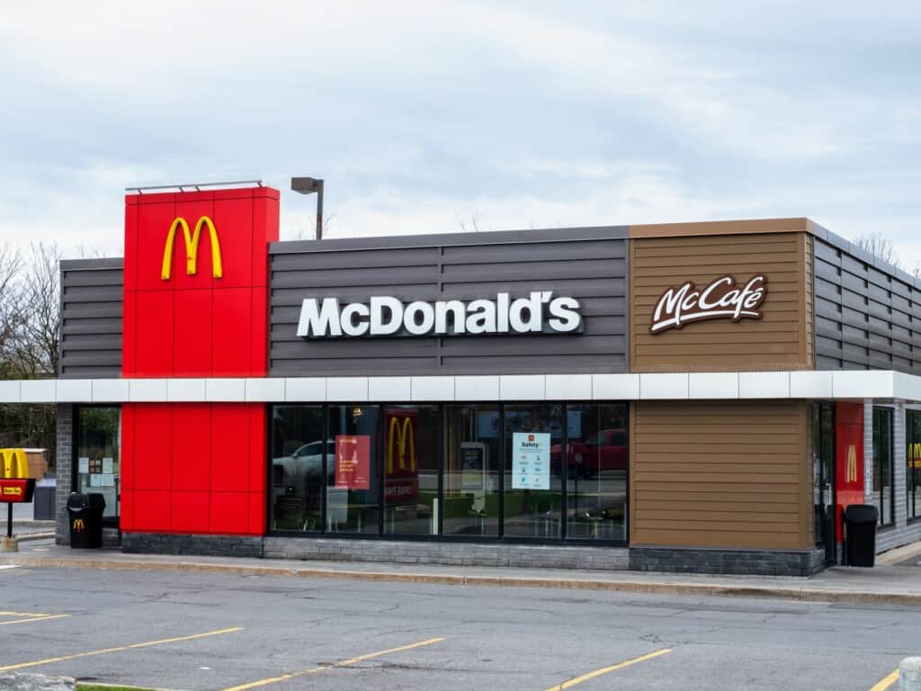 landscape of a mcdonalds with a parking lot in foreground