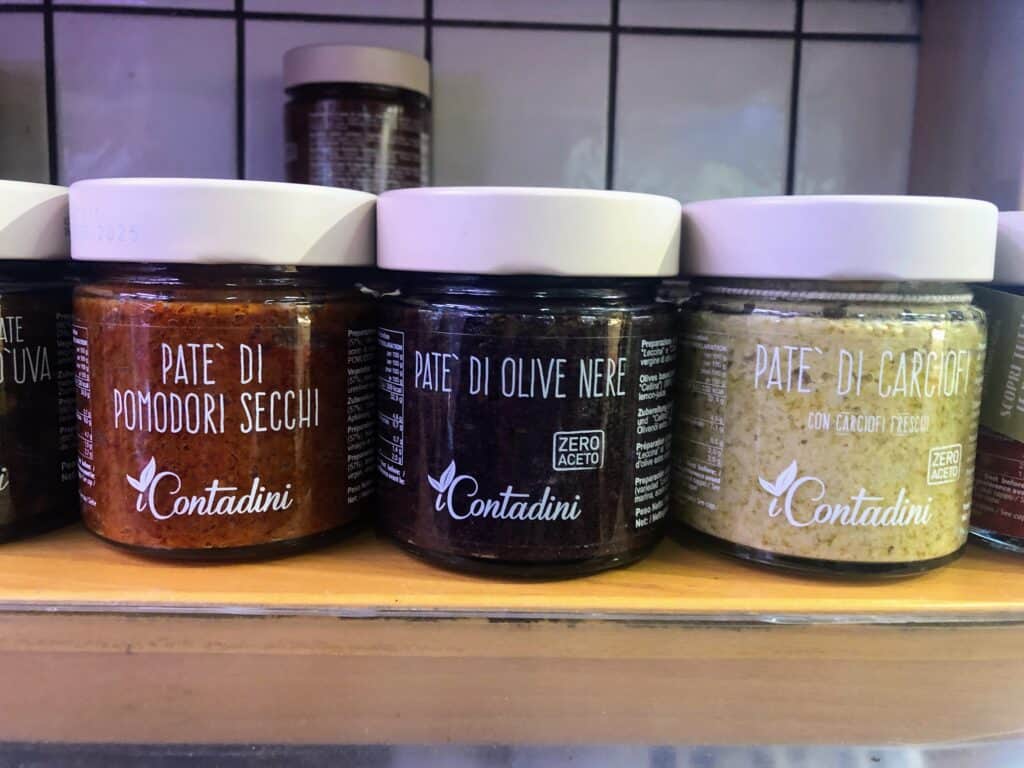 Close up of jars of pates on sale in an Italian shop.