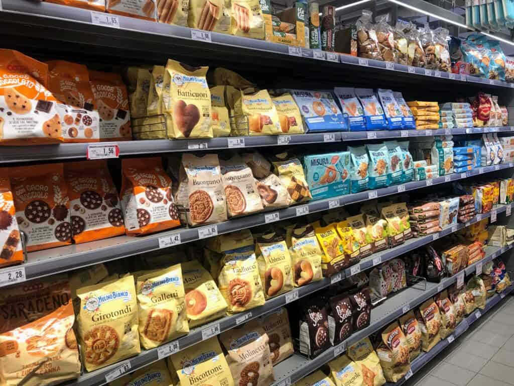 Packaged Italian cookies on display in an aisle of a grocery store in Italy.