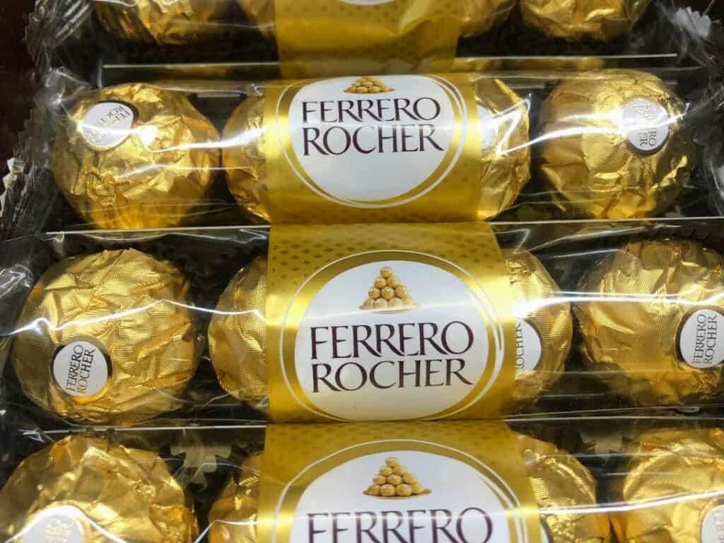Close up of gold-wrapped Ferrero Rocher chocolates.
