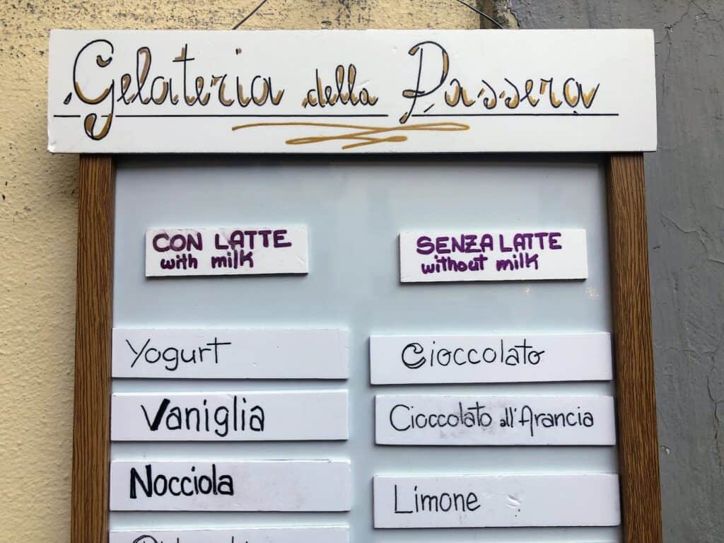 Sign outside Gelateria della Passera in Florence, Italy that has gelato with and without milk (con o senza latte).  