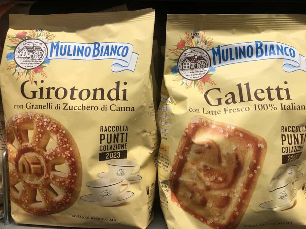 Close up of two yellow packages of Mulino Bianco Italian cookies.