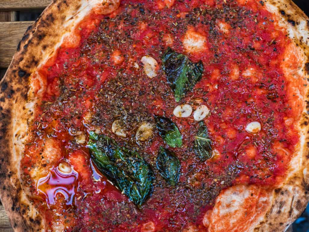 Close up of marinara pizza, a vegan meal in Italy.