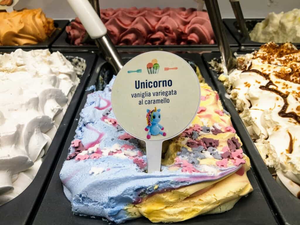 Close up of a colorful unicorn flavor of gelato at a gelateria in Italy.