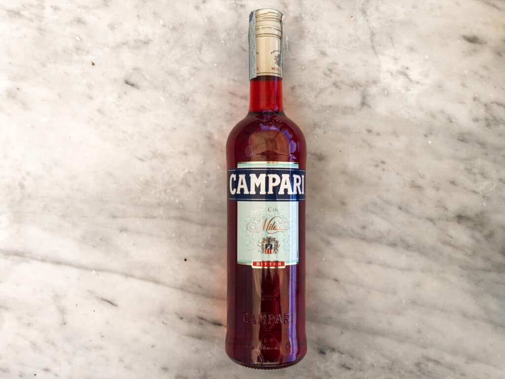 top view of campari bottle on a marble board from top view