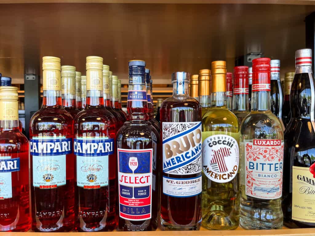 line of various campari brands lined up at a supermarket for sale on a shelf