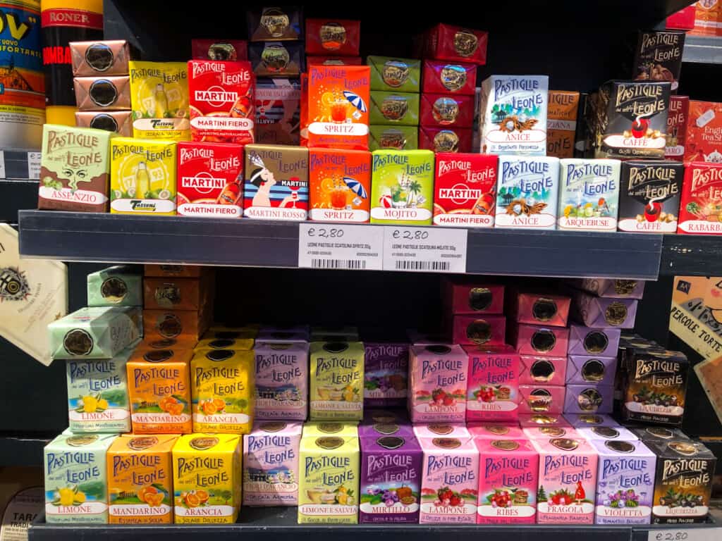 selection of leone pastiglie candies for sale in three rows with various colors and flavors with price tags underneath