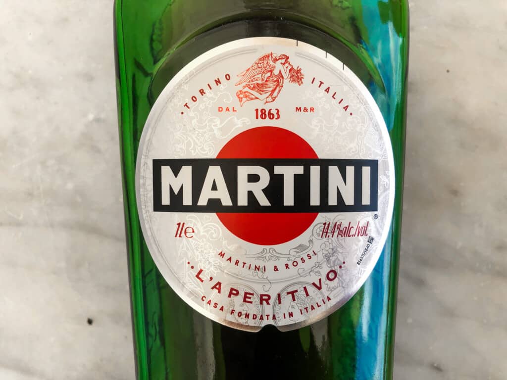 close up top view of martini vermouth green bottle on marble countertop