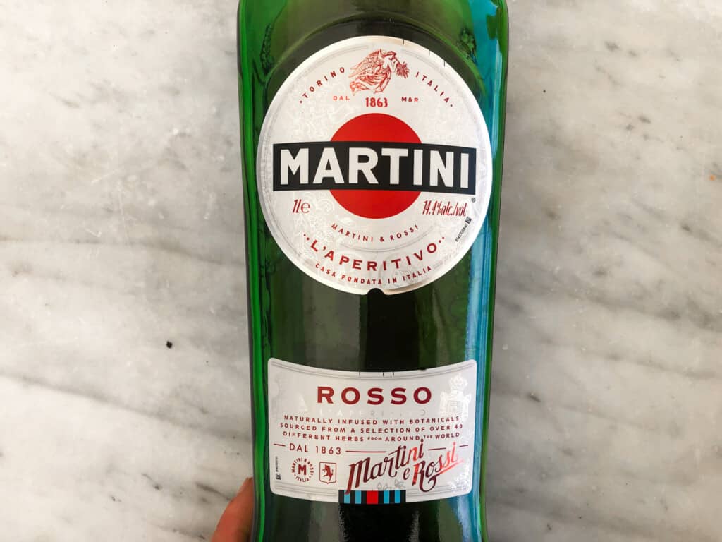 close up of bottle of Martini sweet red vermouth on a marble surface