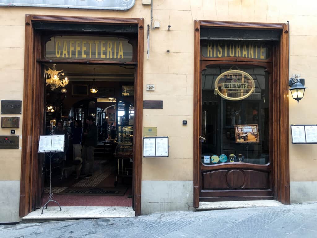 street bar of a fancy bar with two doors with caffetieria and ristorante written on top of either door