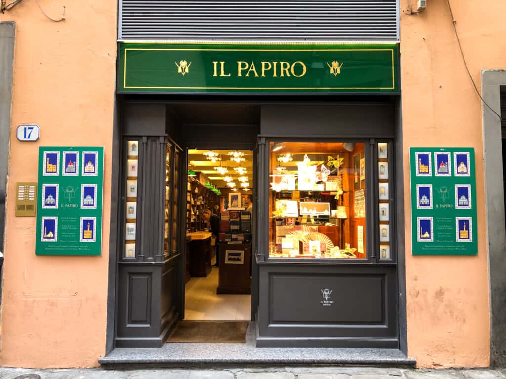 street view of papiro with a large top green sign with gold writing on top and charcoal walls