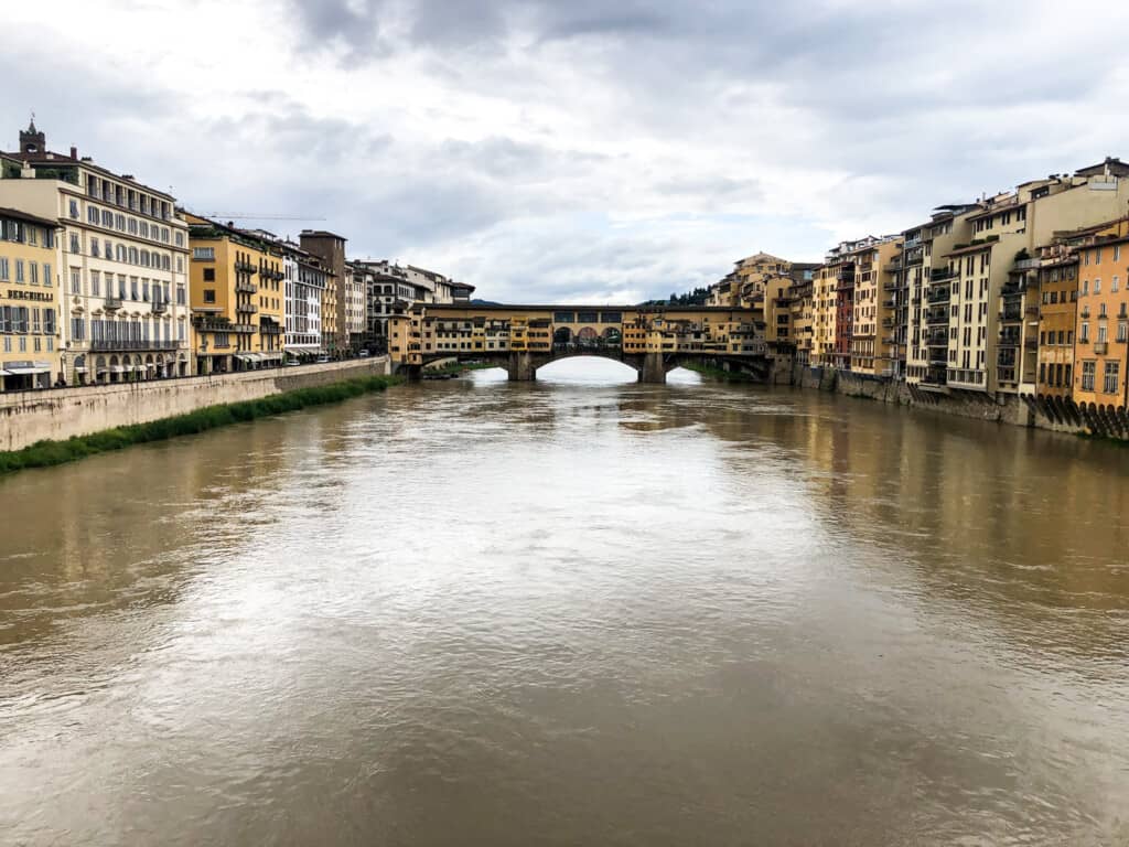 view of ponte vecchio side image from far on a partly cloudy day