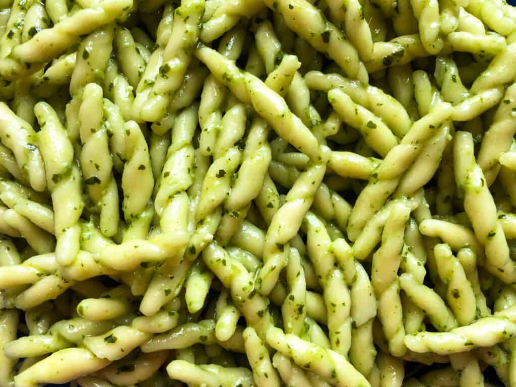 close up view of trofie with pesto top view