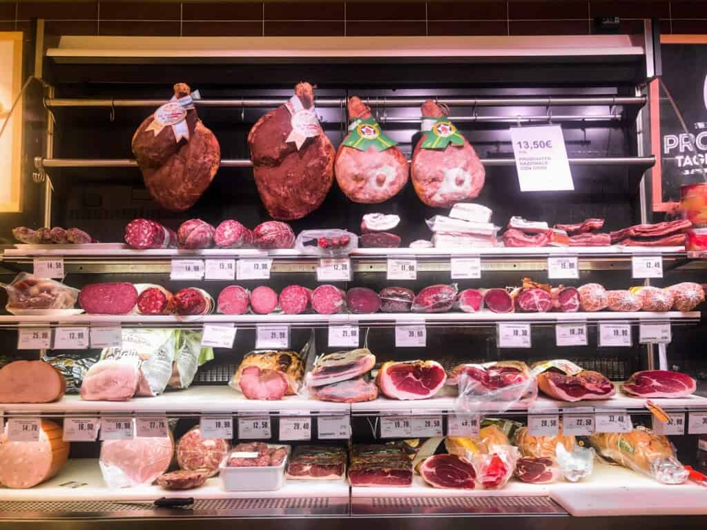 View of meat display at an Italian supermarket deli.