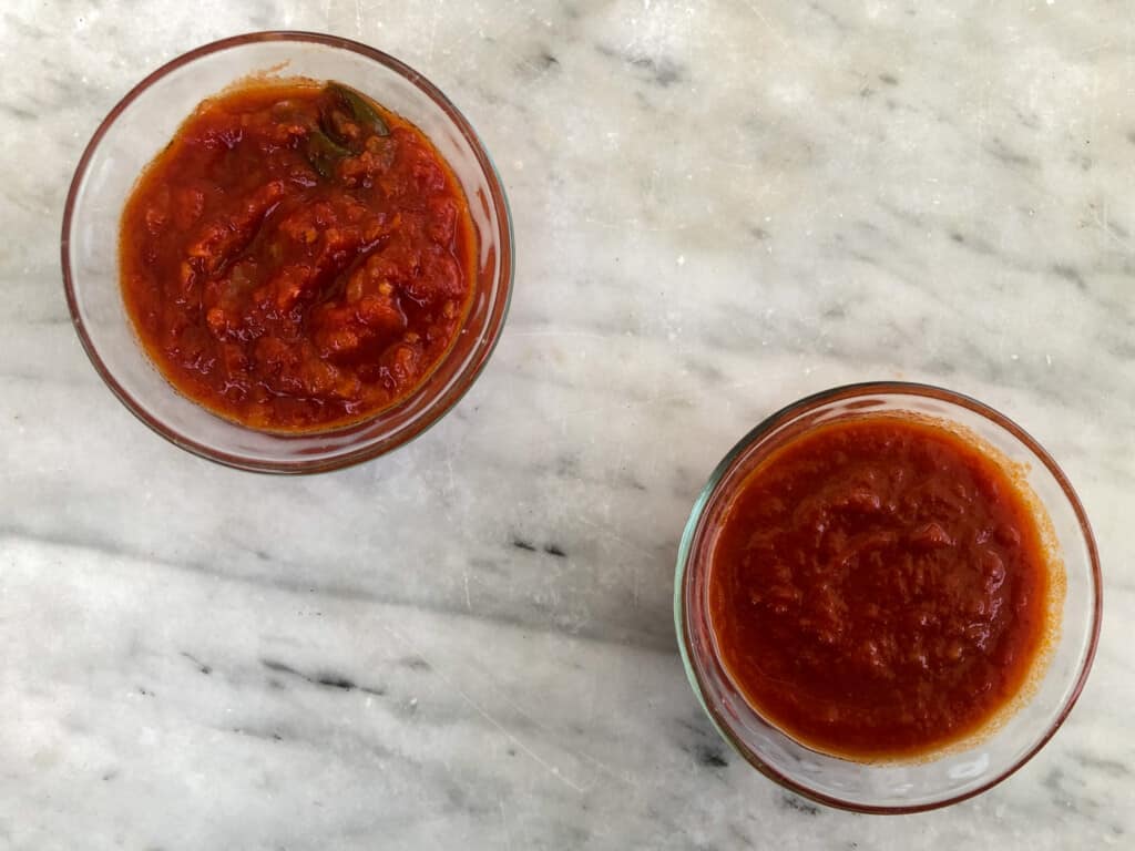 Looking down at two glasses filled with pomodoro sauce - the left is chunky and the right is smooth.
