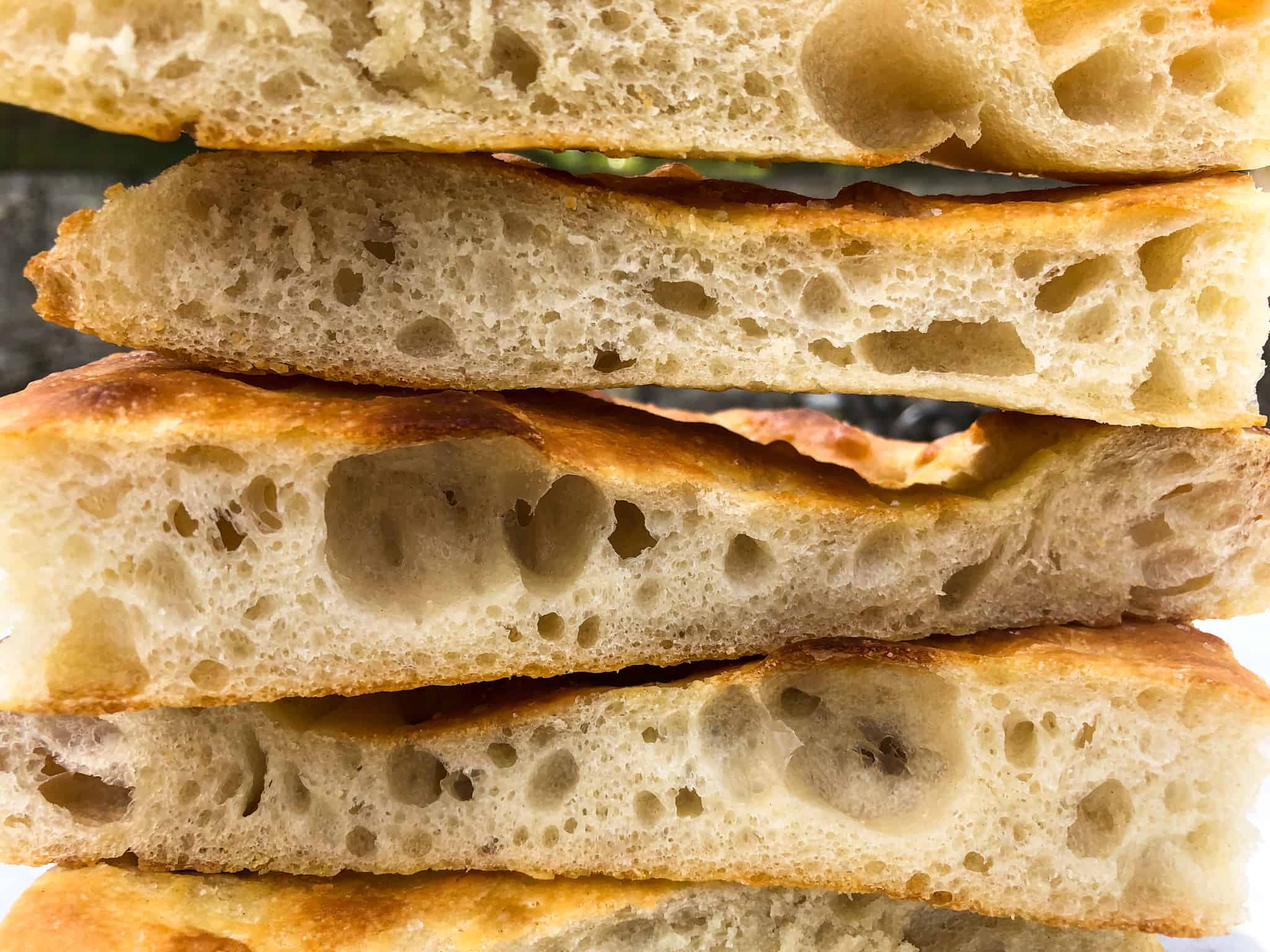 Close up side view of sliced schiacciata stacked up.