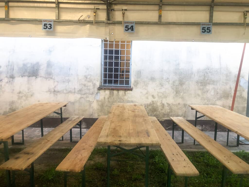 long, wooden tables with numbers written above