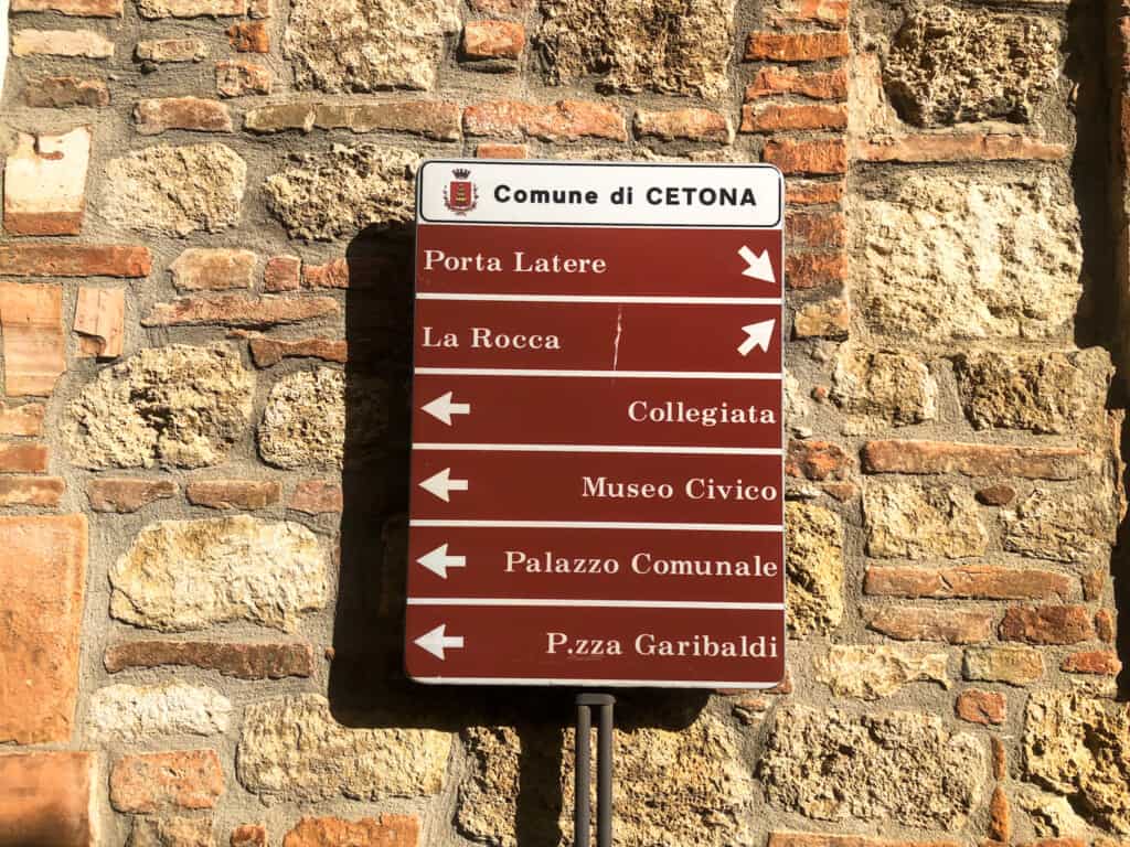 Brown indication signs in Cetona, Italy. They point to historic and cultural monuments.