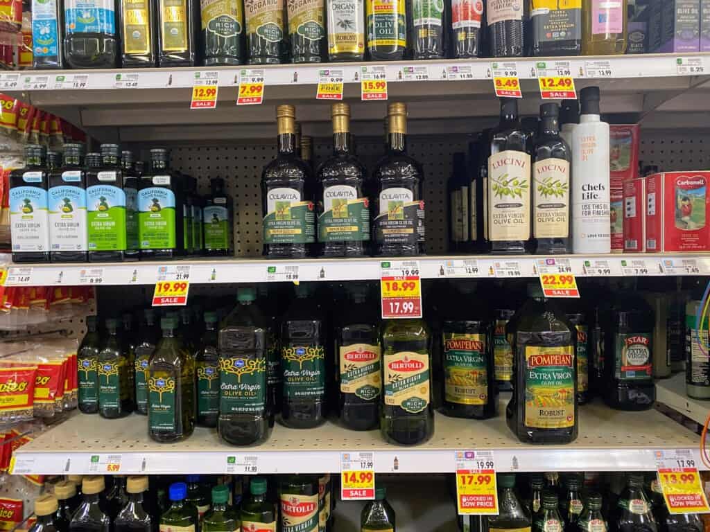 Grocery store shelves full of bottles of olive oil in the USA.