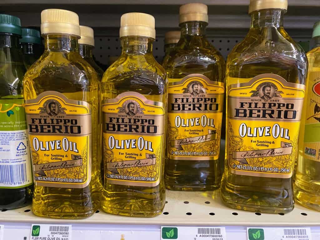 Bottles of Filippo Berio olive oil on a grocery store shelf in the United States of America.