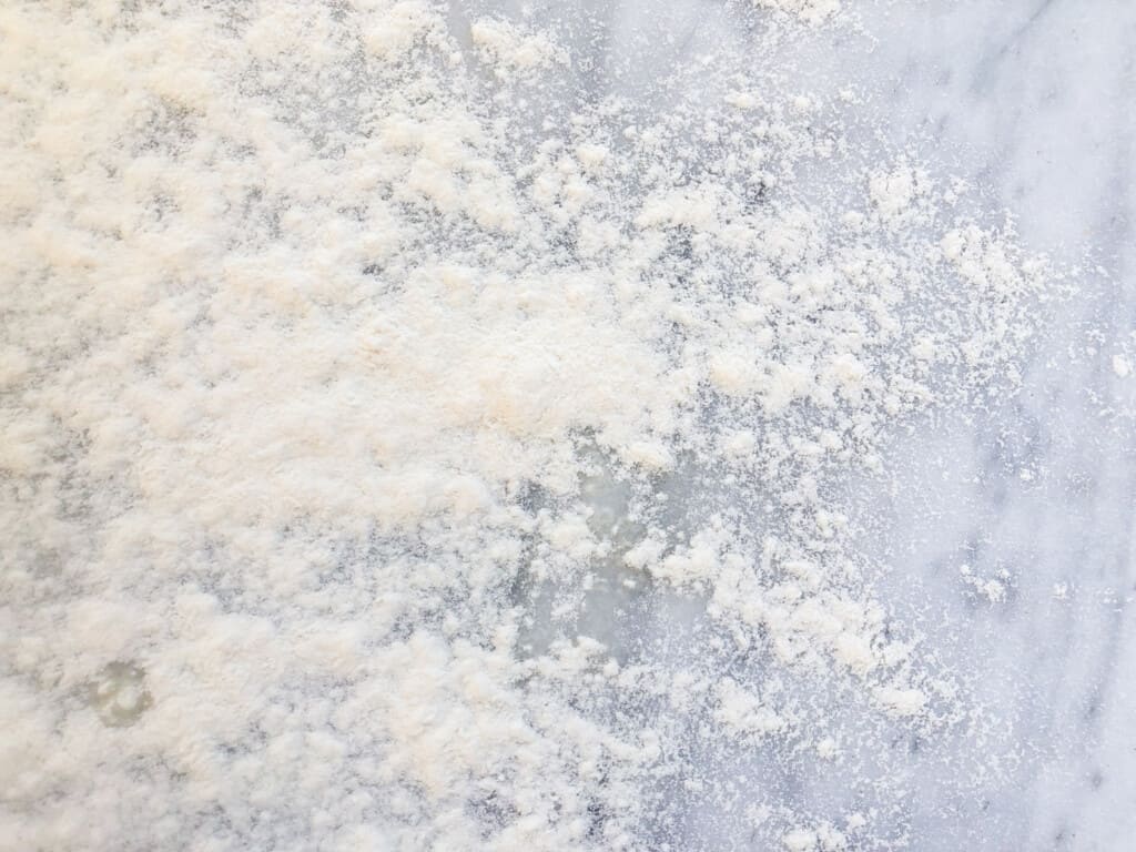 Flour scattered on white marble surface.