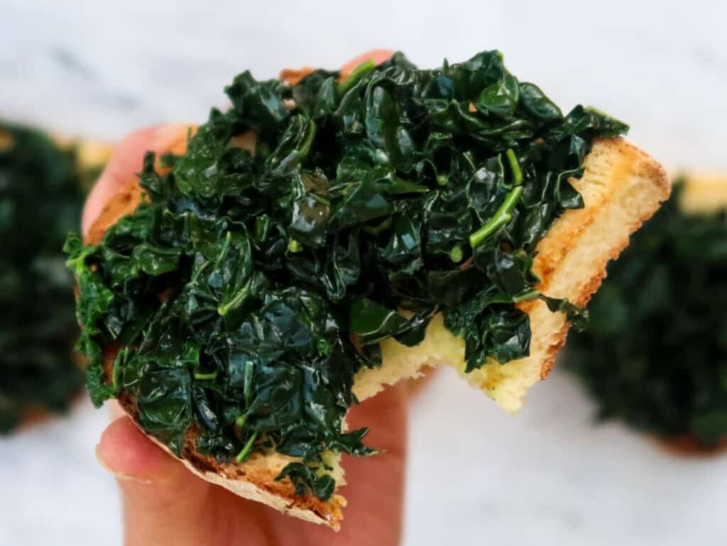 Toasted Tuscan bread with cooked Tuscan kale (cavolo nero) on top.