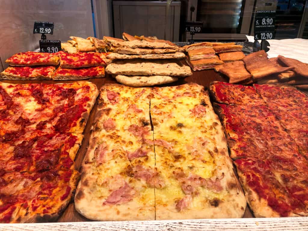 Pizza on display at an Italian grocery store.