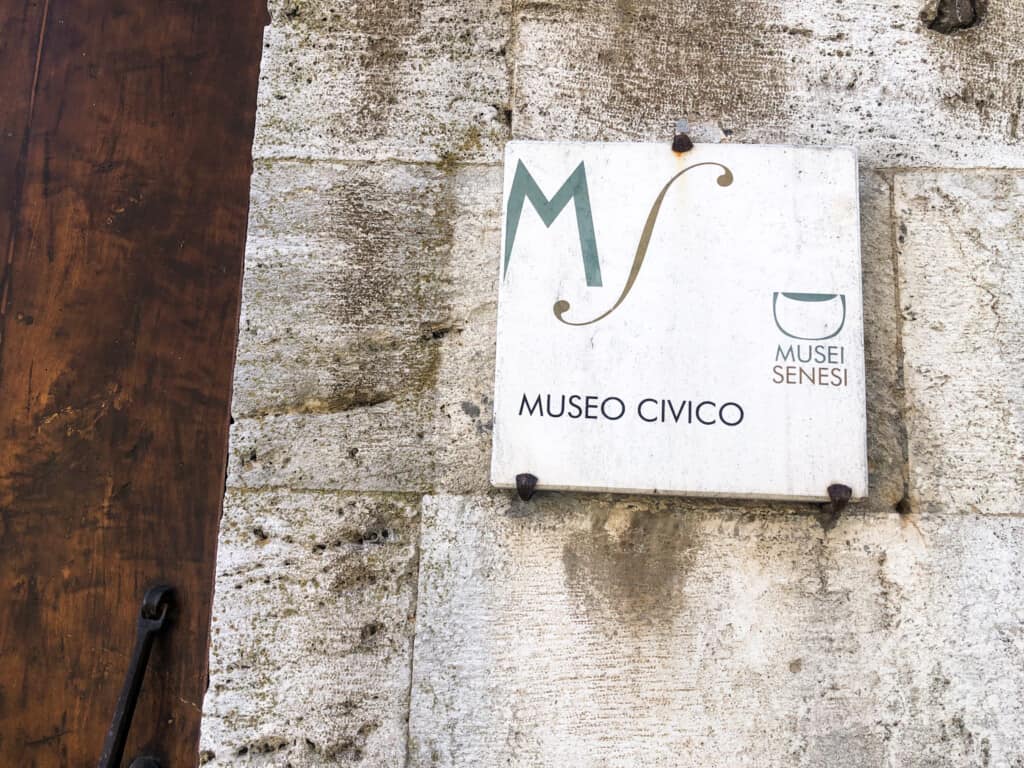 Tile sign for Museo Civico on a stone wall in Montepulciano.