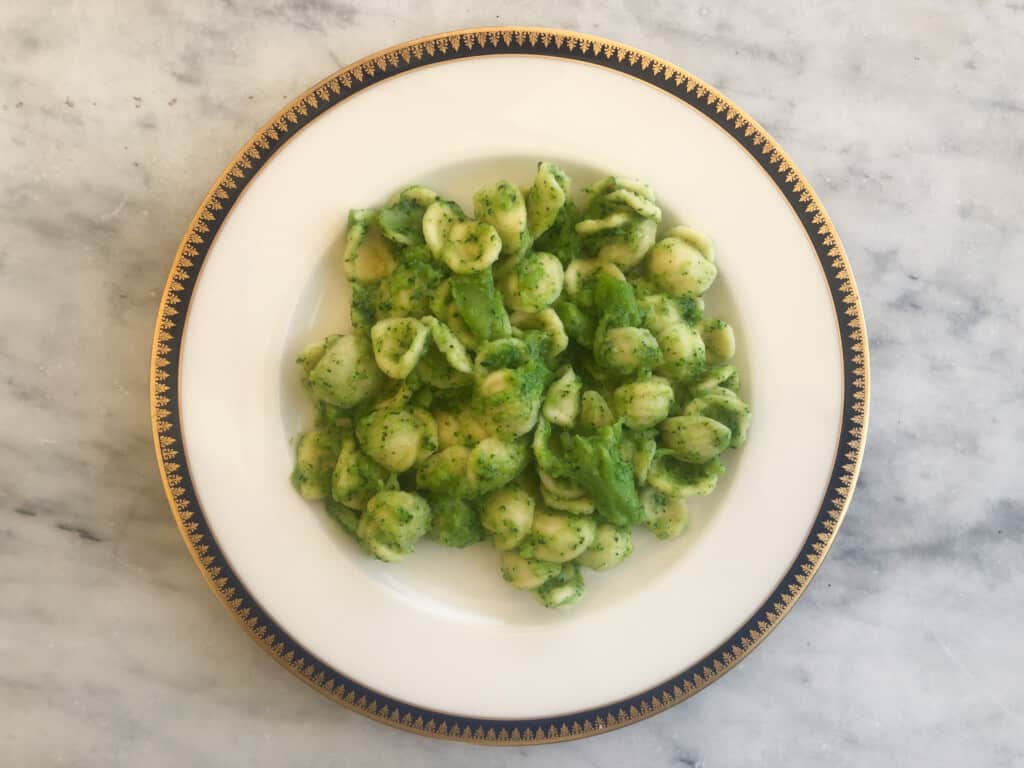 Plate of orecchiette pasta with a broccoli pesto.