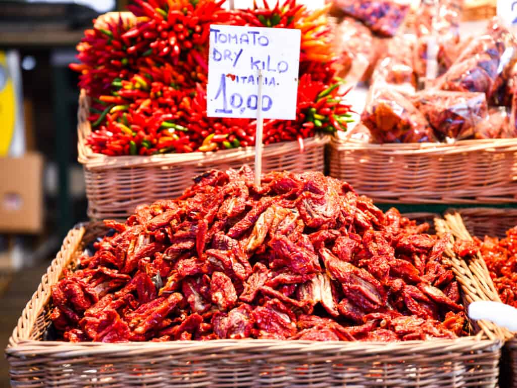 Basket of sundried tomatoes with price tag at the Rialto Market in Venice, Italy.