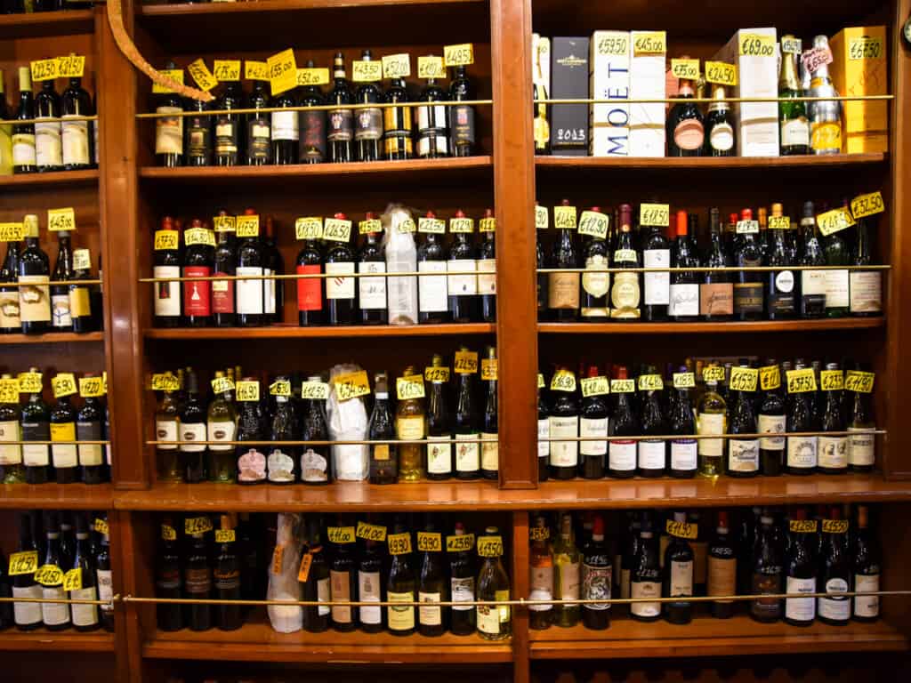 Wall display of wines for sale in a shop in Venice, Italy.