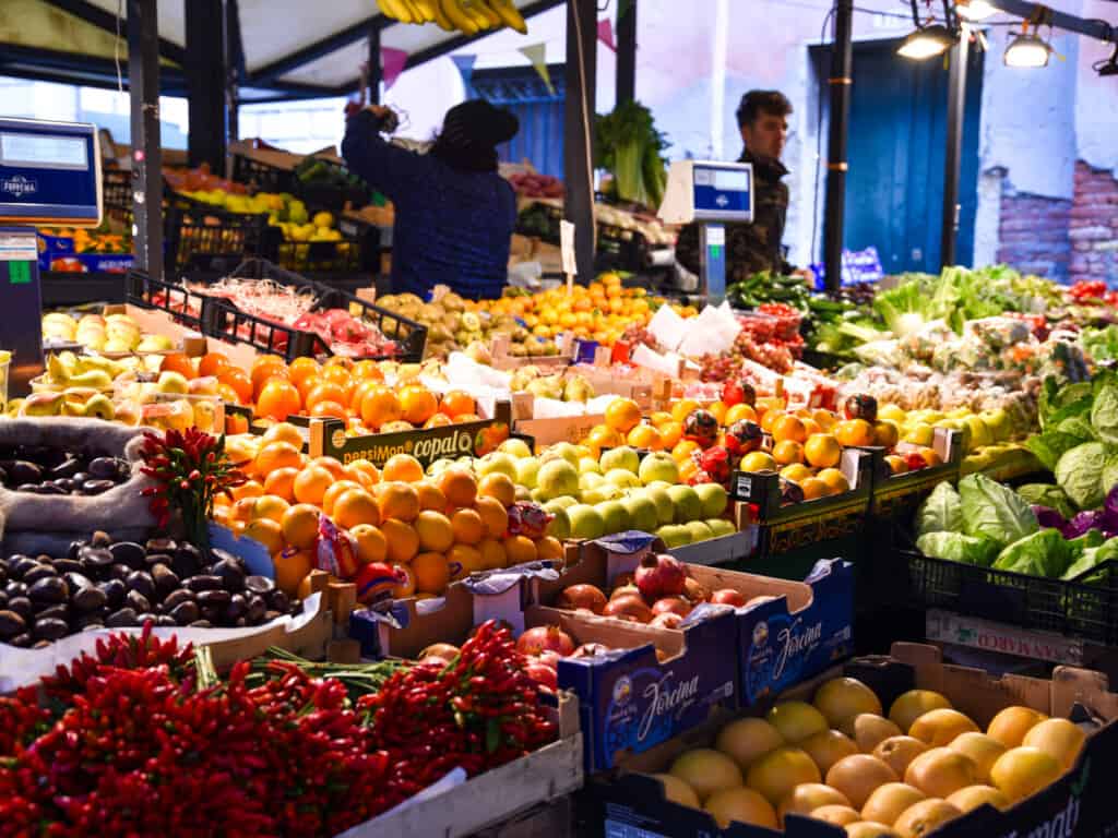 Boxes of fresh fruits and vegetables displayed at a stand in the morning at the Rialto Market in Venice, Italy.