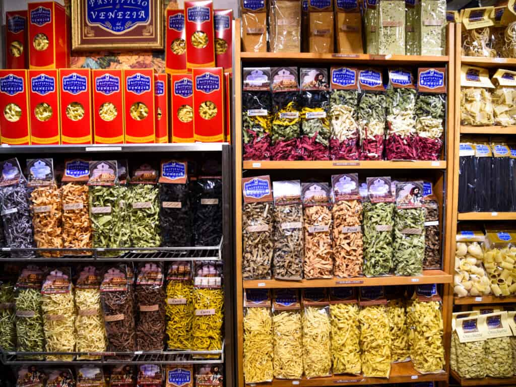 Wall of colorful variety of pasta for sale in shop in Venice, Italy.