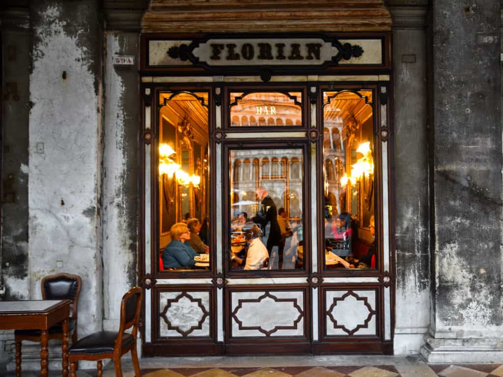 Entrance to Florian Bar in Venice, Italy. People dining inside.