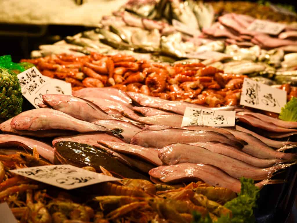 Display of fish and seafood with prices at the Rialto Market in Venice, Italy.