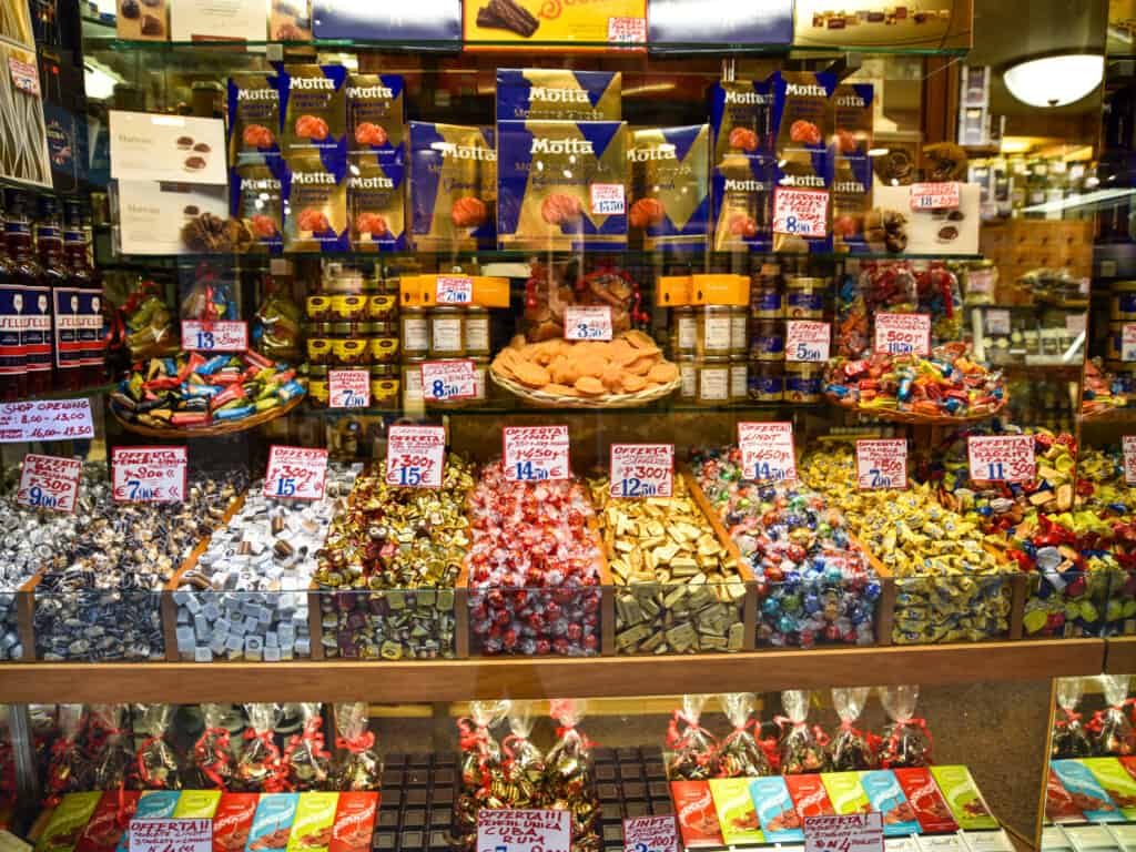 Window display of candies and cookies in Venice, Italy shop.