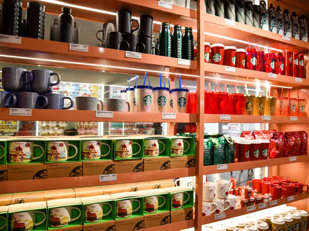 Starbucks merchandise on shelves at a store in Italy.