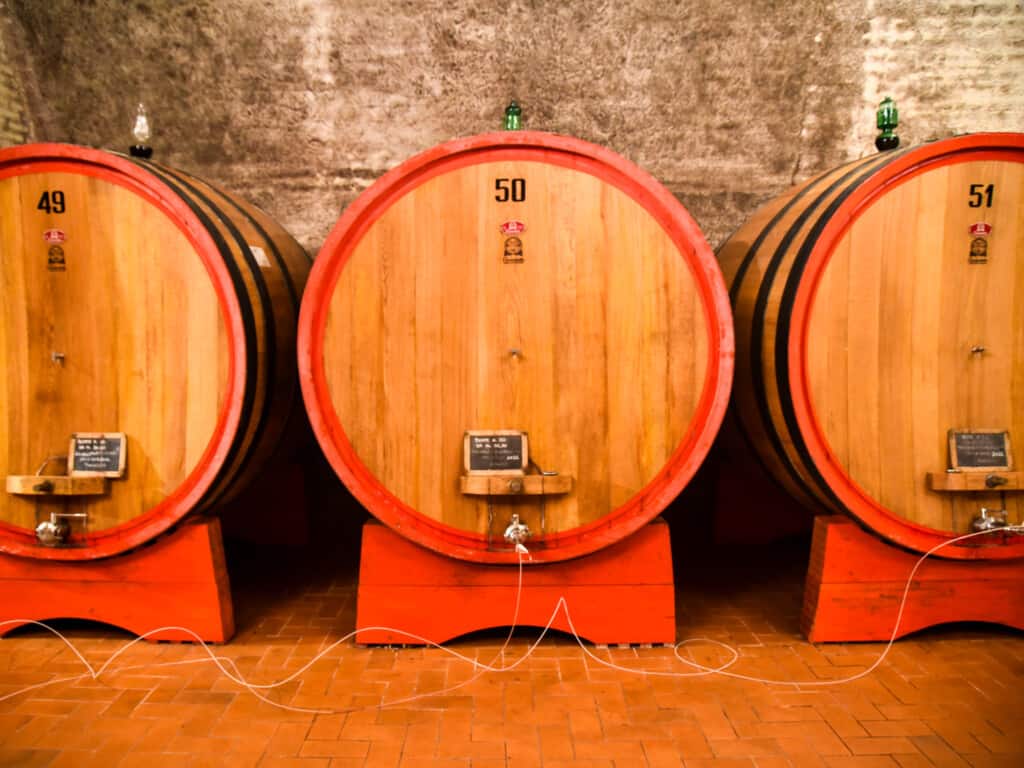 Huge wooden wine barrels line the walls at Valdipiatta Winery in Montepulciano, Italy.
