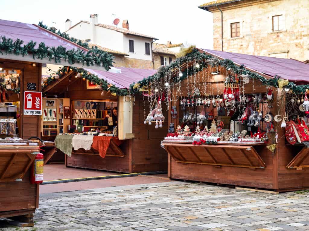 Wooden stalls in a stony piazza at the Christmas Market in Montepulciano, Italy.